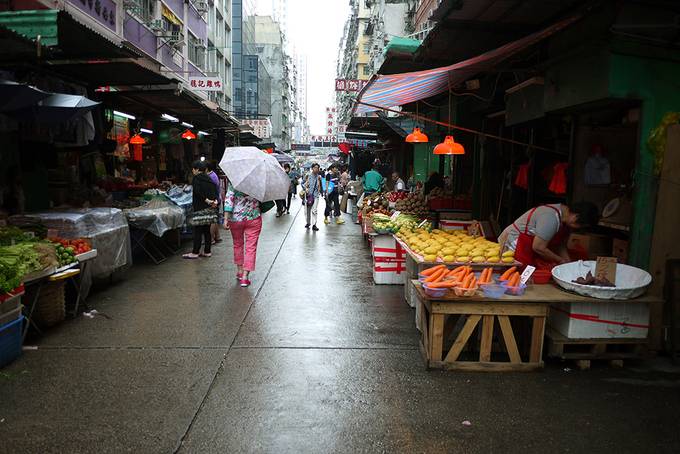 lady walking in rain in Hong Kong market lady walking in rain in Hong Kong market